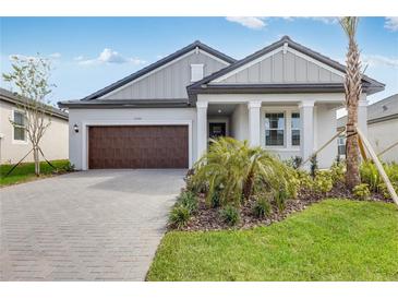 Charming single-story home with a two-car garage, manicured lawn, and beautiful landscaping at 31764 Griffin Sands Ln, San Antonio, FL 33576