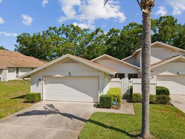 Charming single-story home featuring a two-car garage and well-maintained landscaping at 456 Lakeview Dr # 5, Palm Harbor, FL 34683