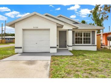 Charming single-story home with a well-maintained lawn and attached garage at 5400 9Th N Ave, St Petersburg, FL 33710