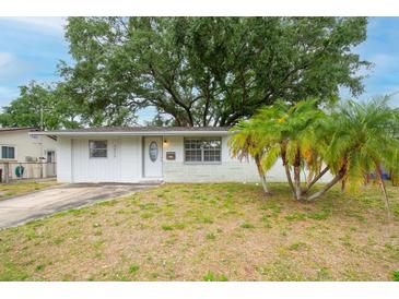 Charming single-story home with a well-maintained front yard and mature trees, offering great curb appeal at 5875 92Nd N Ave, Pinellas Park, FL 33782