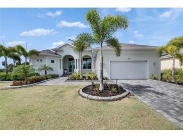 Charming single-Gathering home with a two-car garage, lush landscaping, and a well-maintained front yard at 706 Manns Harbor Dr, Apollo Beach, FL 33572