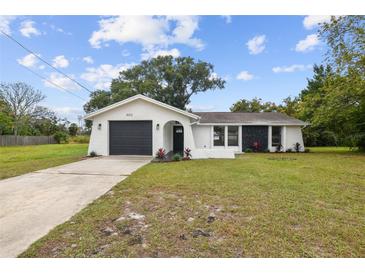 Charming single-story home boasts a modern exterior with a well-maintained front yard at 8512 Longboat Ln, Hudson, FL 34667