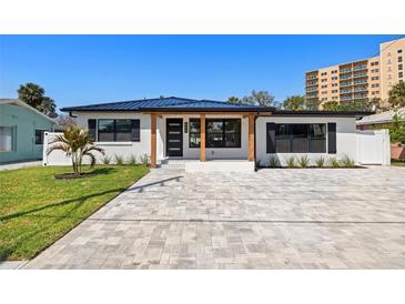 Charming home featuring modern upgrades, a new roof, and a spacious paver driveway at 864 Mandalay Ave, Clearwater Beach, FL 33767