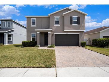 Charming two-story home with a well-manicured lawn, two-car garage, and a welcoming front porch at 13802 Kinsale St, Riverview, FL 33579
