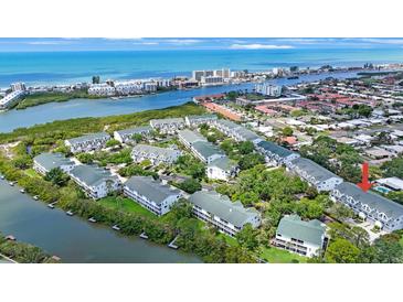 Beautiful aerial view of waterfront condos with lush landscaping, and Gulf of Mexico in the background at 14649 Seminole Trl # 5, Seminole, FL 33776