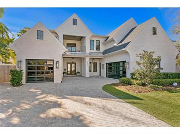 Beautiful two-story home featuring brick, two-car garages, and a manicured lawn with a paved driveway at 1903 S Cardenas Ave, Tampa, FL 33629