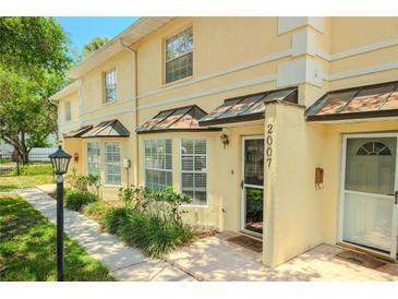 Charming two-story townhome with well-maintained landscaping and inviting front entrance at 2007 W De Leon St # C, Tampa, FL 33606