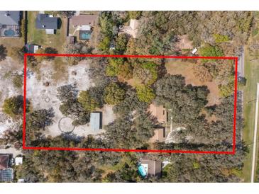 Large acreage lot with mature trees and a building highlighted by a red border and surrounding neighborhood at 6718 Watson Rd, Riverview, FL 33578