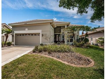 Charming single-story home showcasing manicured landscaping and a two-car garage at 1522 Riverdale Dr, Oldsmar, FL 34677