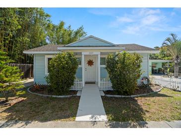 Charming, light blue home featuring a welcoming entrance and well-maintained landscaping at 2610 58Th S St, Gulfport, FL 33707