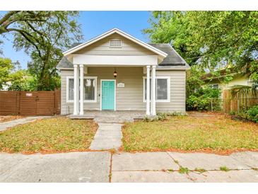 Charming single story home with a covered front porch and a welcoming blue door at 2708 N Mitchell Ave, Tampa, FL 33602