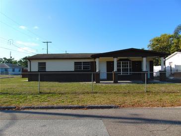 Charming single-story home featuring a covered porch and well-maintained lawn at 3002 W Haya St, Tampa, FL 33614