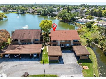 Aerial view of property overlooking a tranquil lake with lush surroundings at 4027 Davit Dr, New Port Richey, FL 34652