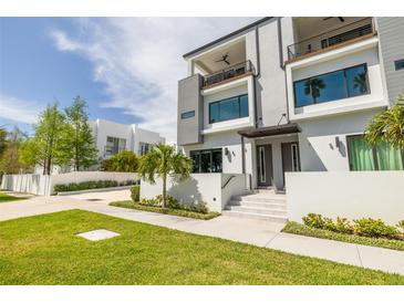 Modern two-story home featuring a manicured lawn and sleek architectural design at 4515 W North A St # 8, Tampa, FL 33609
