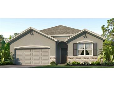 Charming one-story home with a symmetrical design and a neutral color palette at 7770 Wheat Stone Dr, Zephyrhills, FL 33540