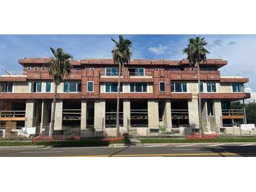 Multi-story building under construction showcasing modern architectural design with large window openings and concrete framework at 85 Davis Blvd # D, Tampa, FL 33606