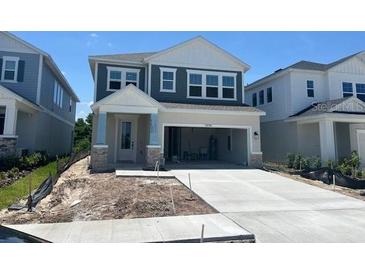 Charming two-story home with light blue siding, white trim, and a spacious two-car garage at 28764 Jujube Rd, Wesley Chapel, FL 33543