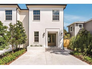 Charming white two-story home with a well-manicured lawn and inviting entrance at 413 W Park Ave # 1, Tampa, FL 33602