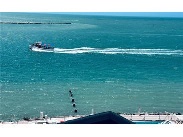 Beautiful turquoise water with a boat offshore, visible from the condominium at 450 S Gulfview Blvd # 802, Clearwater Beach, FL 33767