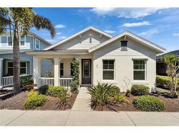 Charming single-story home with a welcoming front porch and well-manicured landscaping at 606 Winterside Dr, Apollo Beach, FL 33572