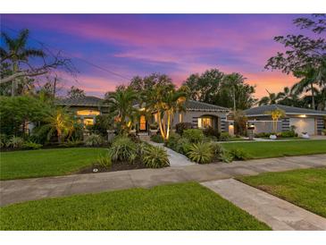 Beautiful single-story home with lush landscaping, lovely walkway, and a charming, inviting curb appeal at 720 Brightwaters Ne Blvd, St Petersburg, FL 33704