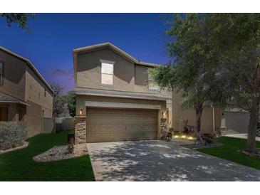 Charming two-story home featuring a two-car garage, landscaped yard, and elegant architectural details at 10524 White Peacock Pl, Riverview, FL 33578