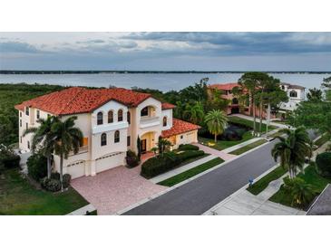 Stunning Mediterranean home with tile roof, manicured landscaping, and picturesque water views from multiple levels at 109 Wateredge Ct, Safety Harbor, FL 34695
