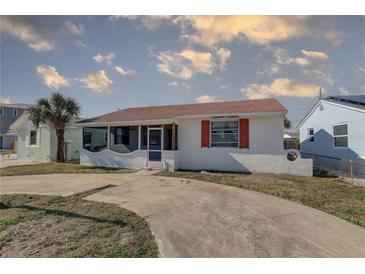 Charming home featuring a cozy screened-in porch and a well-kept front yard at 440 S Bayshore Dr, Madeira Beach, FL 33708