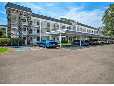 Beautiful multi-story condo complex featuring convenient covered parking and well-maintained grounds at 4801 Airport Rd # 118, Zephyrhills, FL 33542