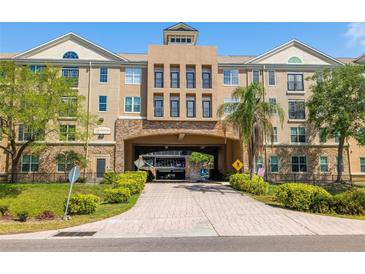 Beautiful condo building featuring a covered driveway and professionally landscaped grounds at 4221 W Spruce St # 1229, Tampa, FL 33607