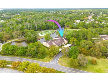 Beautiful condo aerial view featuring a well-maintained exterior, lush landscaping, and golf course views at 50 St Andrews Pl # 50, Oldsmar, FL 34677
