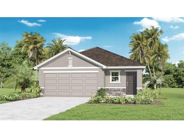 Charming single-story home with a two-car garage, stone accents, and lush landscaping at 5224 Salt Marsh Rd, Wimauma, FL 33598