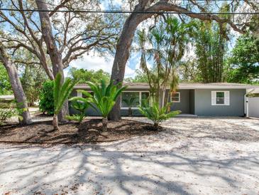 Charming single-story home with mature trees and lush landscaping, offering a serene and inviting curb appeal at 623 15Th Nw Ave, Largo, FL 33770