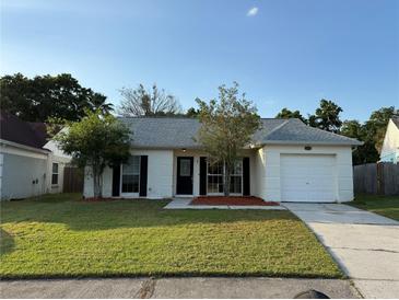 Charming single-story home with a well-manicured lawn and an attached garage at 2140 Redleaf Dr, Brandon, FL 33510