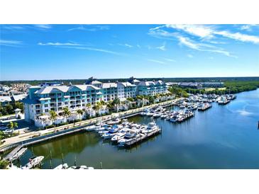 Breathtaking aerial view of luxury condo buildings, yachts, and a stunning waterfront at 525 Bahia Beach Blvd, Ruskin, FL 33570