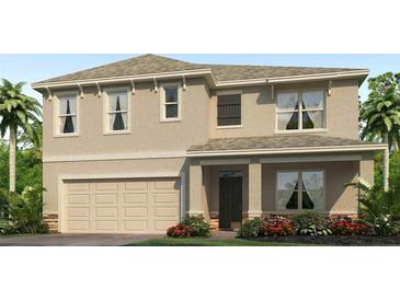 Two-story home featuring a welcoming front porch, a two car garage, and neat landscaping at 7154 Beaverhead Ln, Land O Lakes, FL 34638