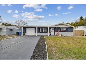 Charming single-story home with an attached carport and meticulously maintained front yard at 3257 Masonville Loop, Holiday, FL 34691