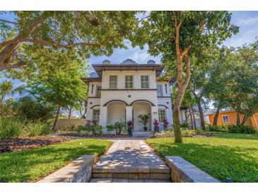 Charming two-story home featuring a beautifully landscaped front yard with a welcoming walkway at 7120 3Rd N Ave, St Petersburg, FL 33710