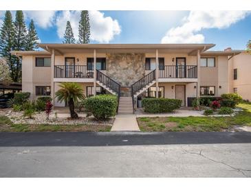 Inviting condo exterior with stone accents, balconies, and well-maintained landscaping at 9910 Eagles Point Cir # 3, Port Richey, FL 34668
