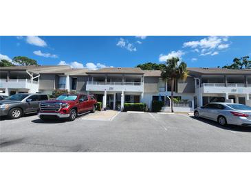 Well-maintained townhouse exterior with neutral colors, covered balconies, and convenient parking at 1960 Lakewood Club Dr S # 2-F, St Petersburg, FL 33712