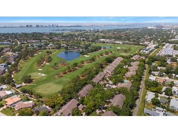 Stunning aerial view showcasing the golf course community, water, and skyline in the distance at 21 Pelican Pl, Belleair, FL 33756