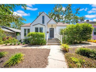 Charming home showcasing a well-manicured lawn, mature trees, and a welcoming front porch at 150 23Rd N Ave, St Petersburg, FL 33704