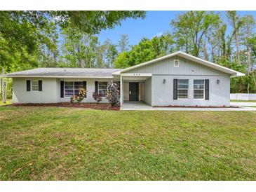 Charming single-story home featuring a well-maintained lawn and inviting front entrance at 346 Ranch Rd, Tarpon Springs, FL 34688