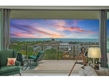 Relax on the balcony with comfortable seating and a telescope while enjoying the beautiful sunset water view at 100 1St N Ave # 1005, St Petersburg, FL 33701