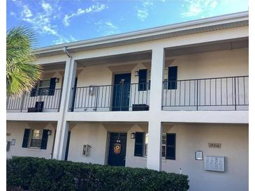 Clean two-story exterior featuring front porches and a well-maintained landscape with shrubbery at 10316 Carrollwood Ct # 57, Tampa, FL 33618