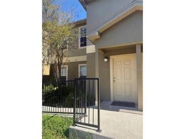 Inviting condo exterior with neutral paint, welcoming front door and small decorative garden at 5904 Willow Ridge Dr # 202, Zephyrhills, FL 33541