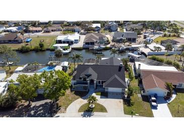 Stunning aerial view of a waterfront home with a private canal and boat dock at 6505 Bimini Ct, Apollo Beach, FL 33572