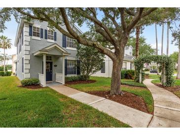 Charming two-story home with blue shutters, a covered porch, and mature trees adding curb appeal at 9106 Crystal Commons Way, Tampa, FL 33626