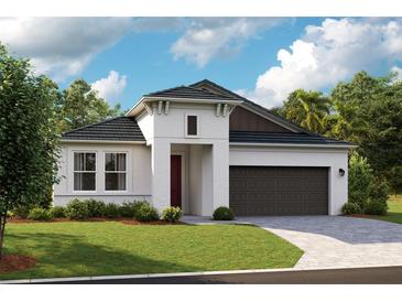 Charming single-story home boasts a modern design, manicured lawn, and a two-car garage at 10049 Surrey Rose Dr, San Antonio, FL 33576