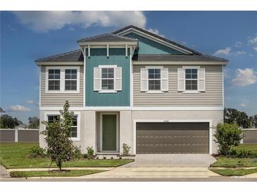 Charming two-story home featuring a modern design, landscaped yard, and a two-car garage at 10243 Fieldstone Myrtle Way, San Antonio, FL 33576